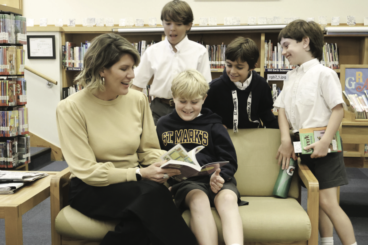 SOUND STORYTELLING Interim Head of Lower School Marion Glorioso-Kirby reads to a group in the Lower School library; she has adapted to her new role quickly.